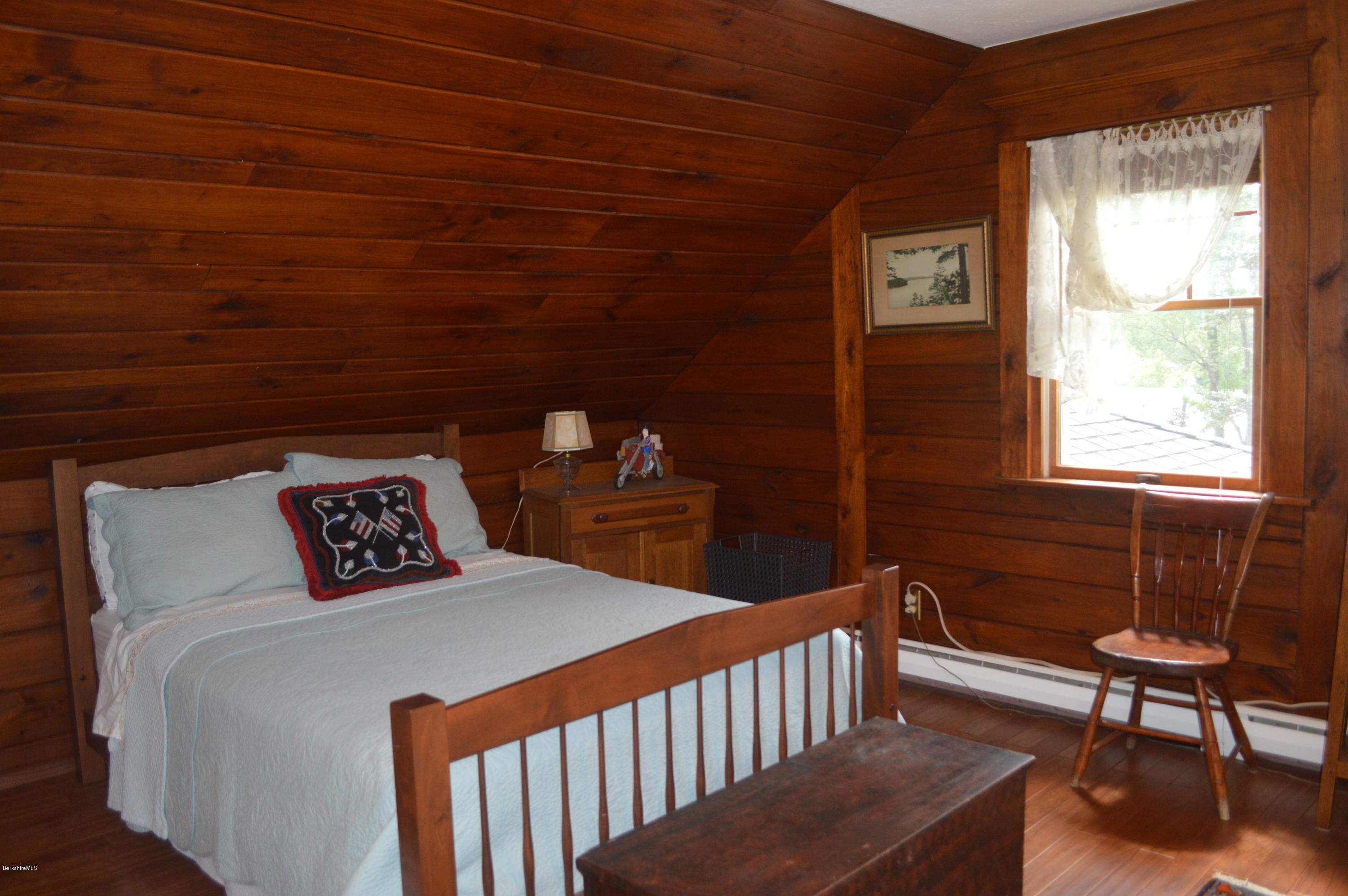 150 Maple Street Lee, MA 01238 - Photo 29 of 57 a bedroom with a bed a table and chair