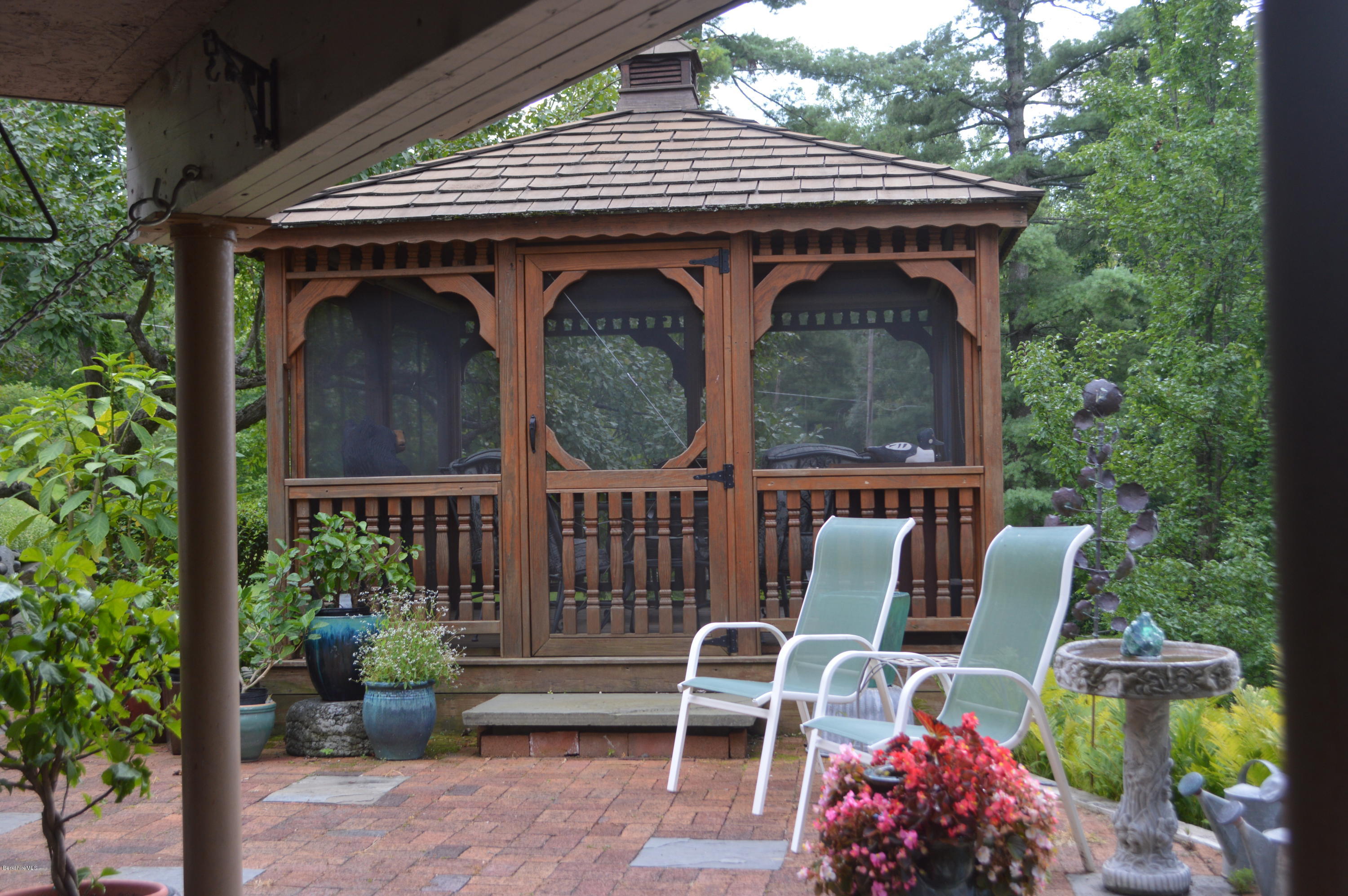 150 Maple Street Lee, MA 01238 - Photo 37 of 57 a view of patio with table and chairs and potted plants