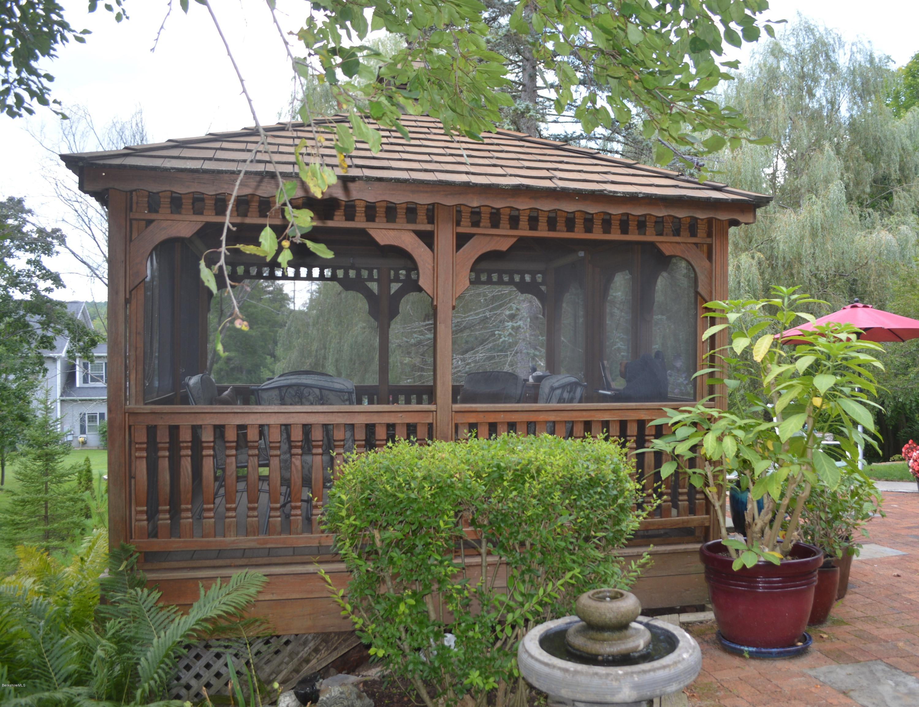 150 Maple Street Lee, MA 01238 - Photo 38 of 57 a front view of house along with deck and outdoor seating