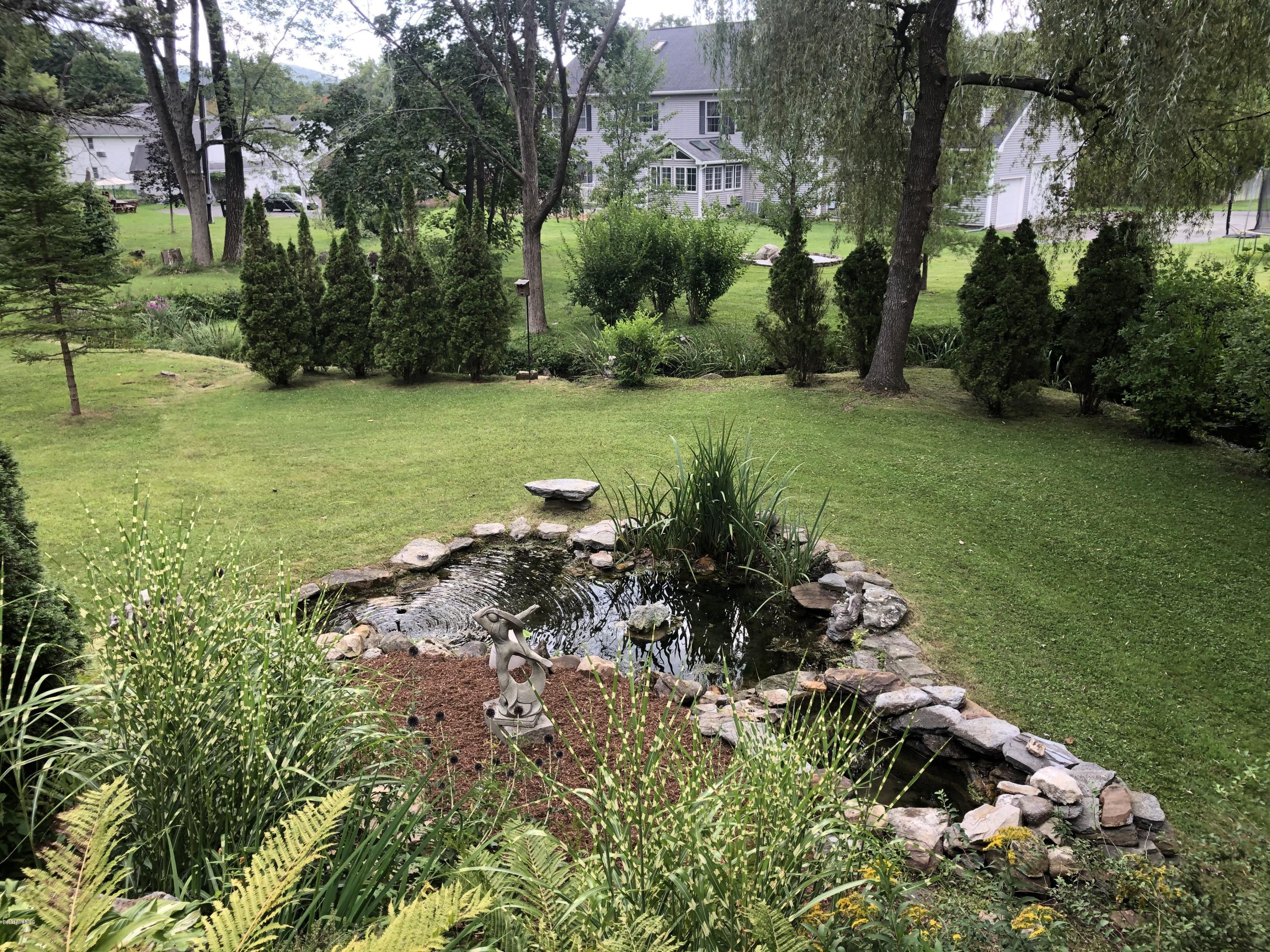 150 Maple Street Lee, MA 01238 - Photo 47 of 57 a view of a garden with a fountain