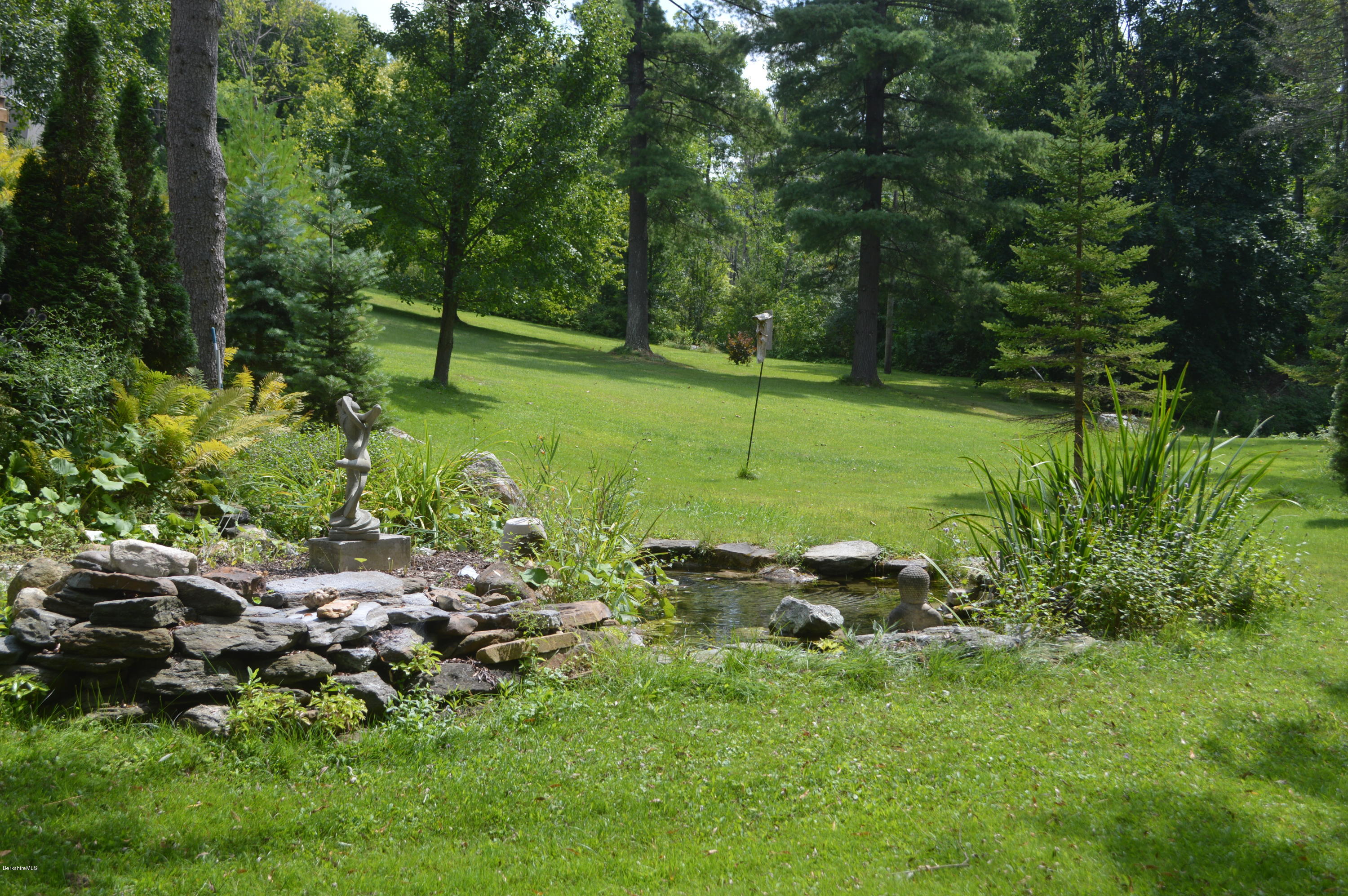 150 Maple Street Lee, MA 01238 - Photo 52 of 57 a backyard of a house with lots of green space
