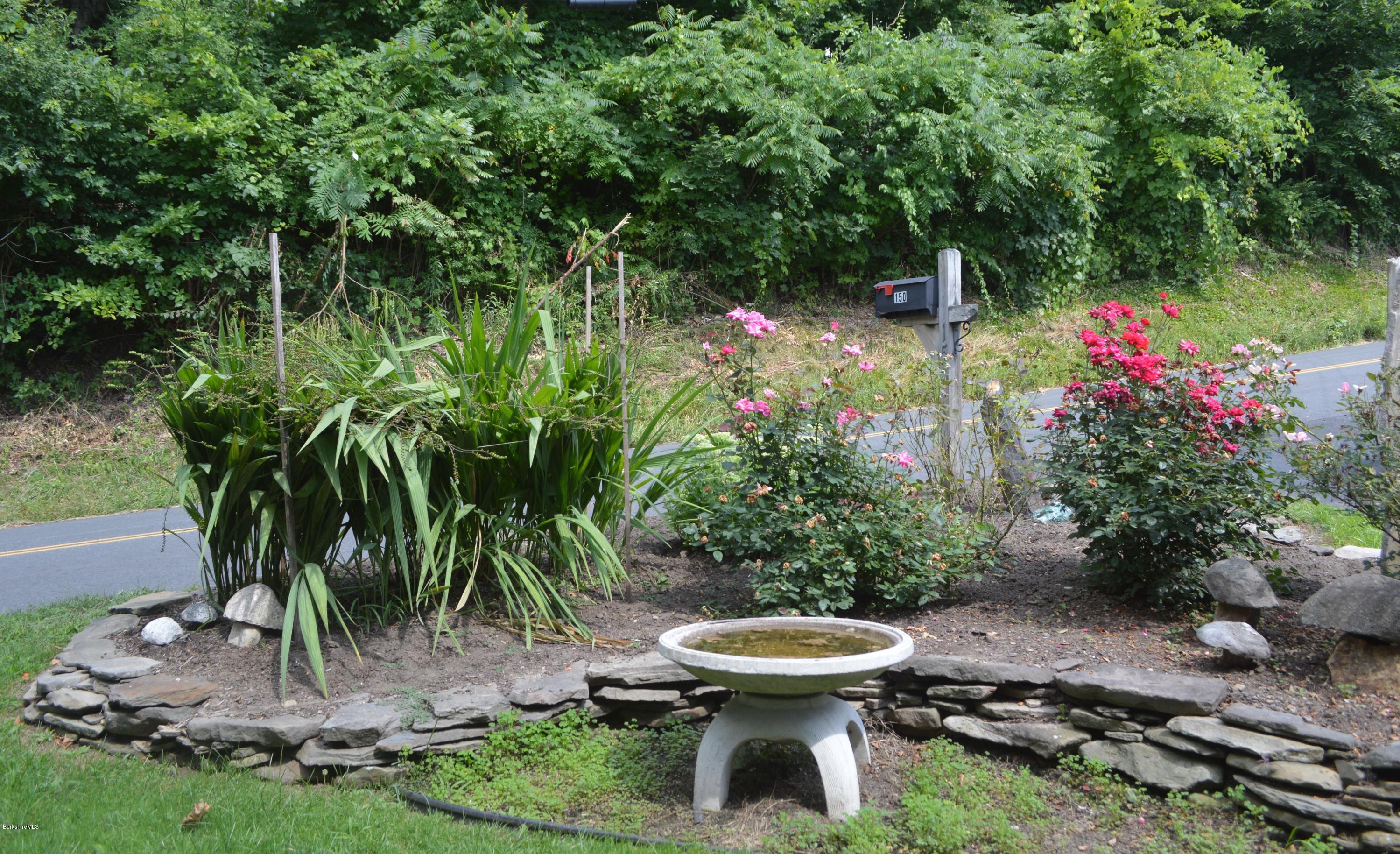 150 Maple Street Lee, MA 01238 - Photo 54 of 57 a view of a backyard with plants and a fountain