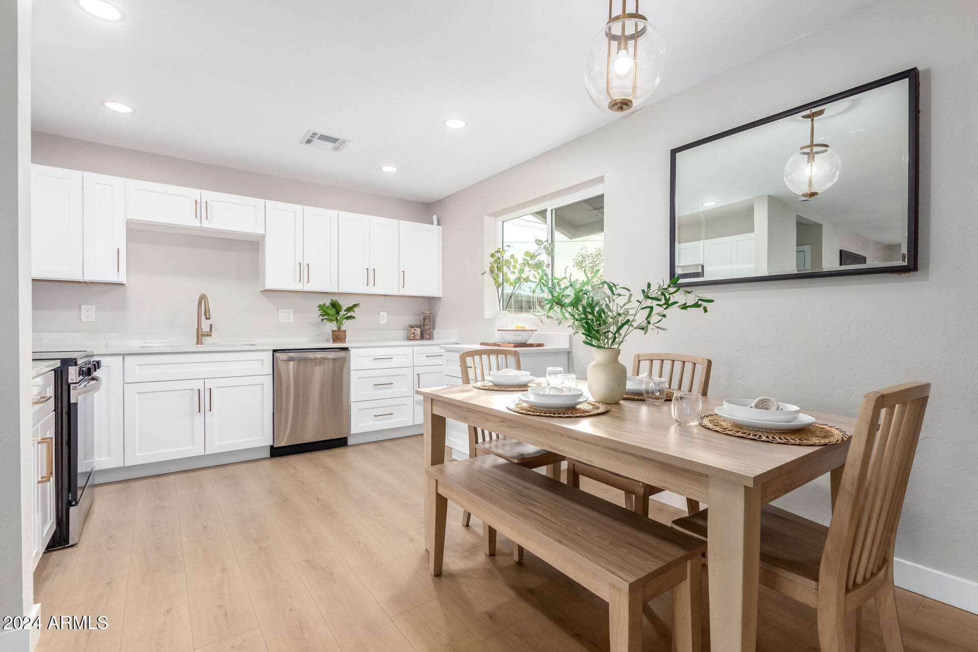 5818 South 20th Street Phoenix, AZ 85040 - Photo 11 of 29 a kitchen with a table chairs sink and cabinets