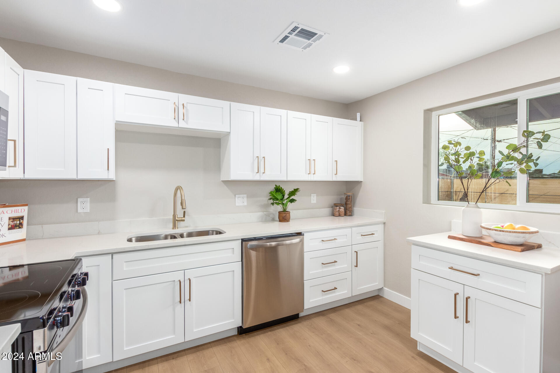 5818 South 20th Street Phoenix, AZ 85040 - Photo 12 of 29 a kitchen with white cabinets appliances and a window