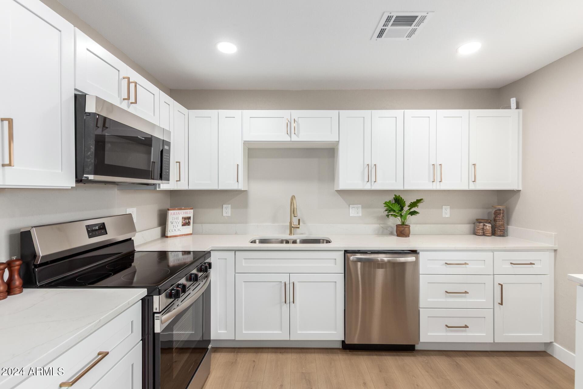5818 South 20th Street Phoenix, AZ 85040 - Photo 13 of 29 a kitchen with stainless steel appliances granite countertop a sink a stove a microwave and cabinets
