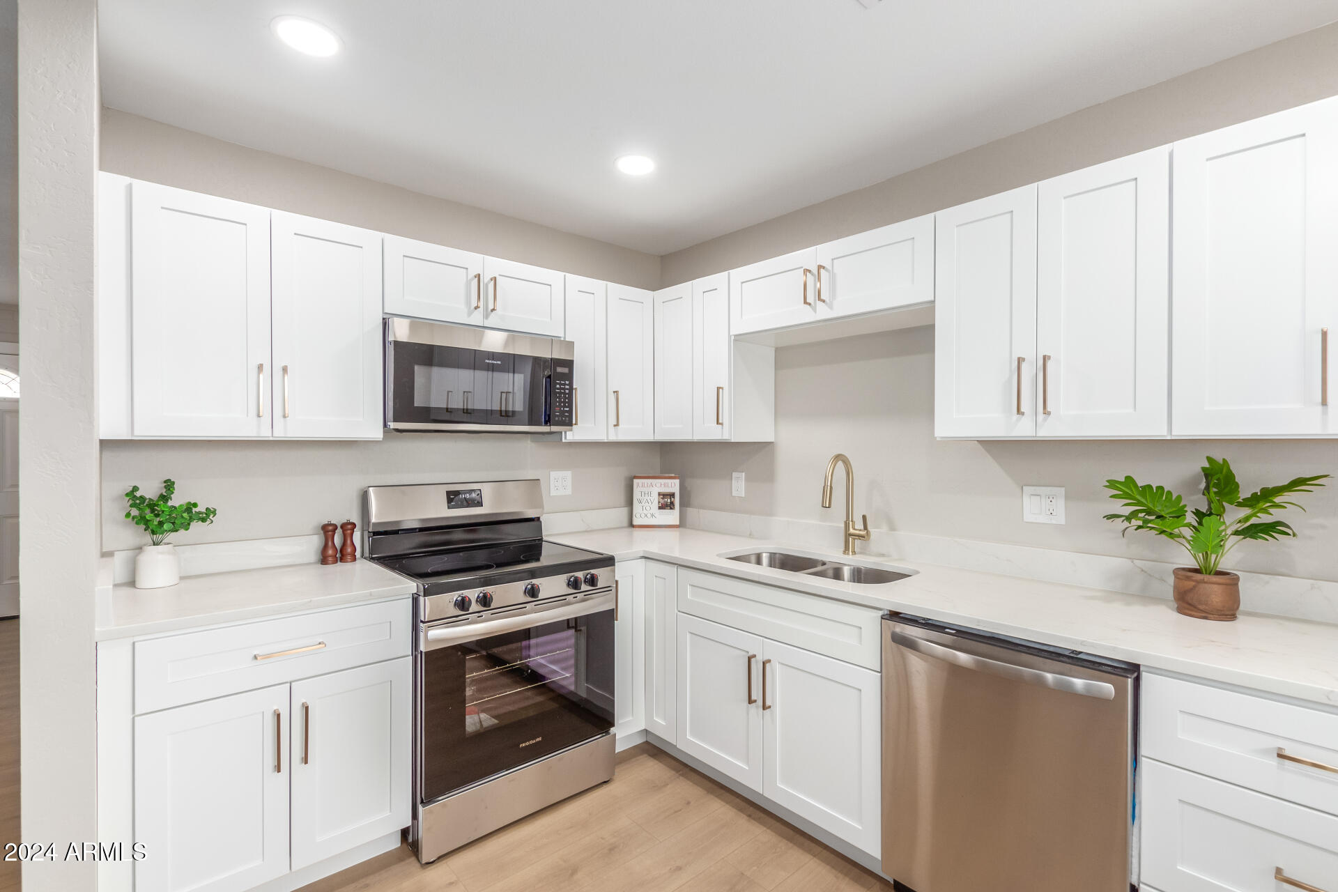 5818 South 20th Street Phoenix, AZ 85040 - Photo 14 of 29 a kitchen with white cabinets stainless steel appliances and sink