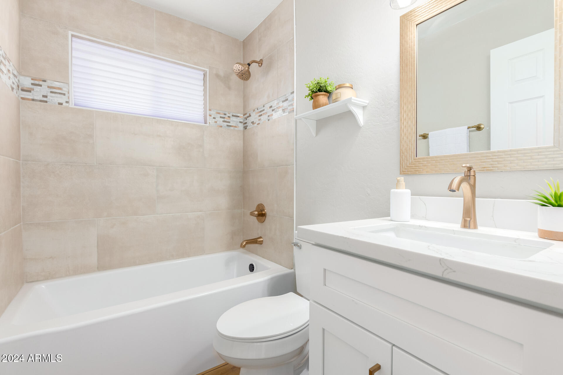 5818 South 20th Street Phoenix, AZ 85040 - Photo 18 of 29 a bathroom with a sink a toilet and bathtub