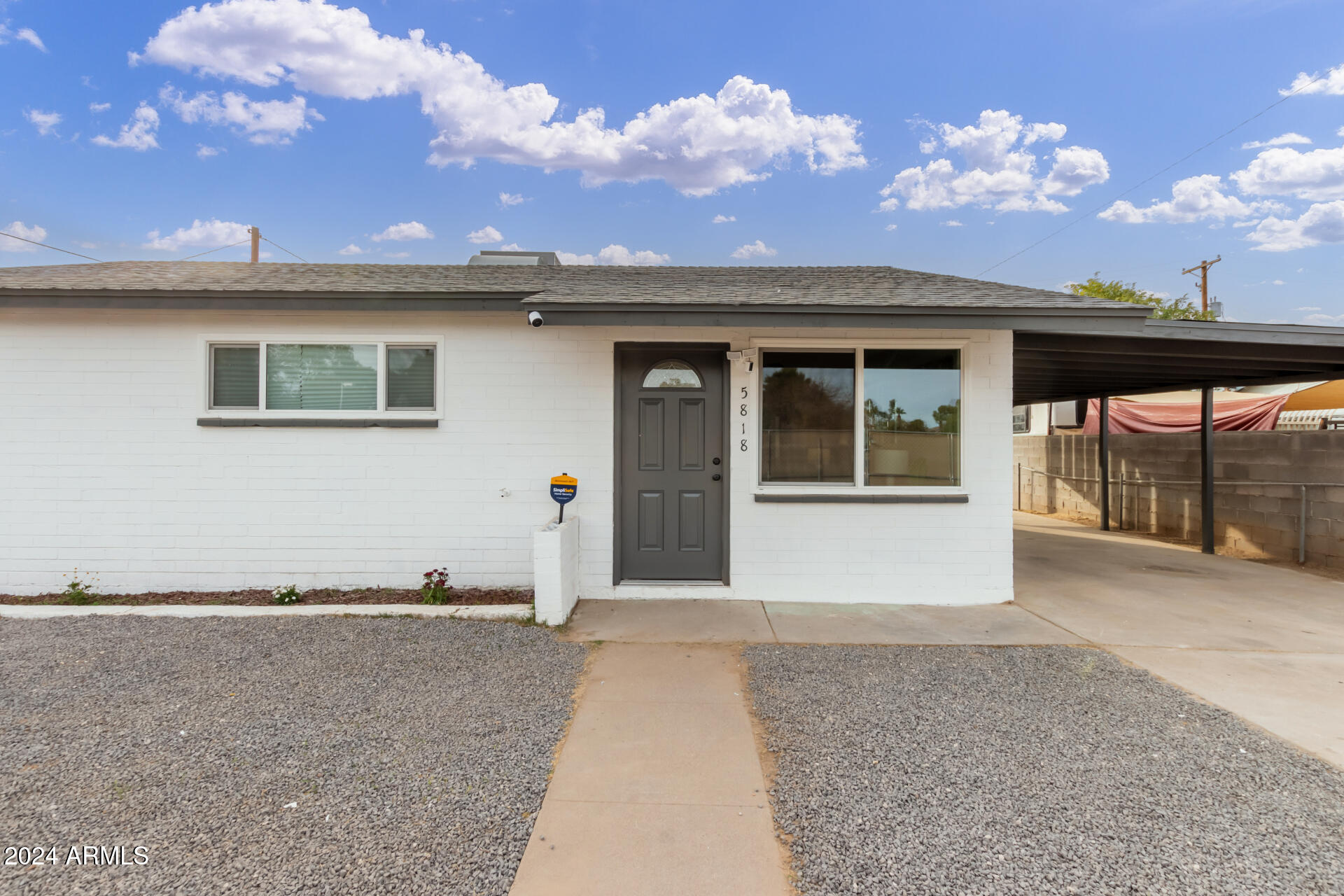 5818 South 20th Street Phoenix, AZ 85040 - Photo 4 of 29 a front view of a house with a garden