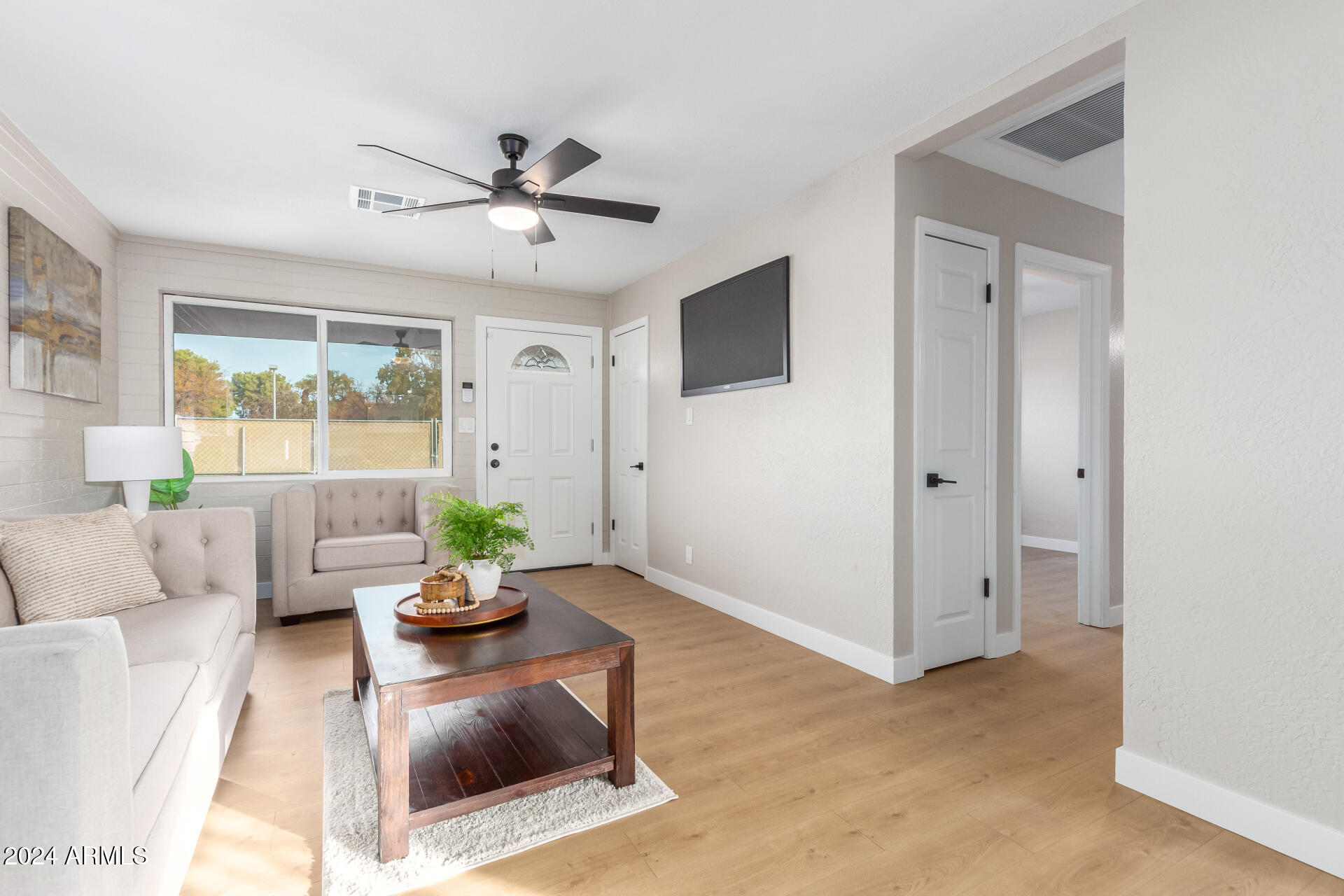 5818 South 20th Street Phoenix, AZ 85040 - Photo 8 of 29 a living room with furniture potted plant and a window