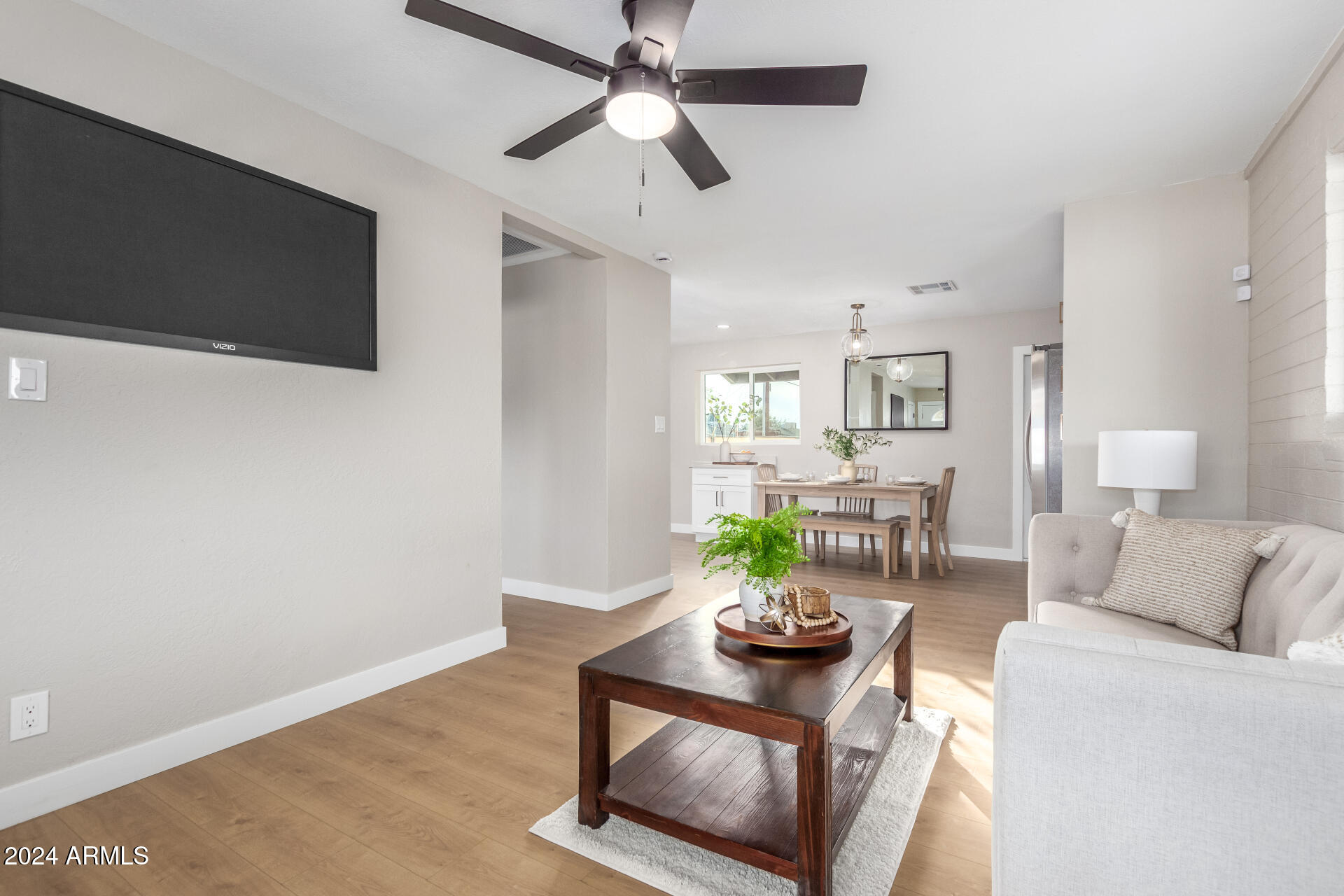 5818 South 20th Street Phoenix, AZ 85040 - Photo 9 of 29 a living room with furniture and a flat screen tv