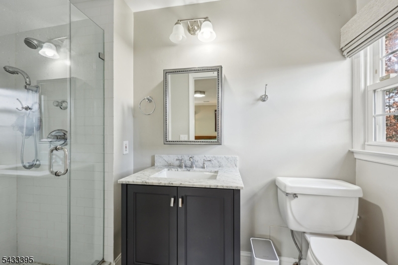48 Woodmont Road Montclair, NJ 07043 - Photo 10 of 20 a bathroom with a sink a toilet and shower
