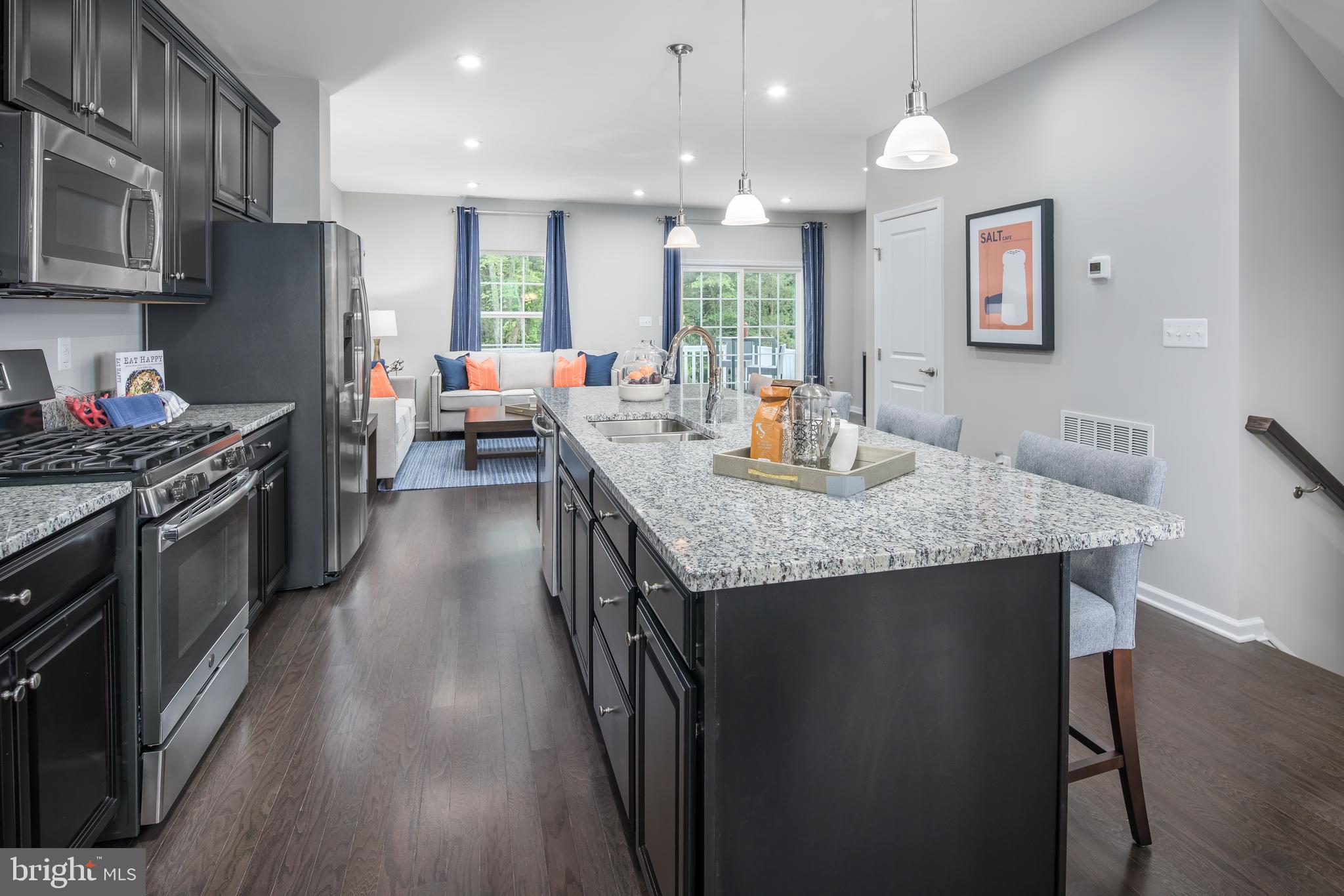 7826 Blackbriar Way, Unit SCHUBERT Laurel, MD 20723 - Photo 1 of 16 a kitchen with granite countertop kitchen island stainless steel appliances a sink stove top oven and refrigerator