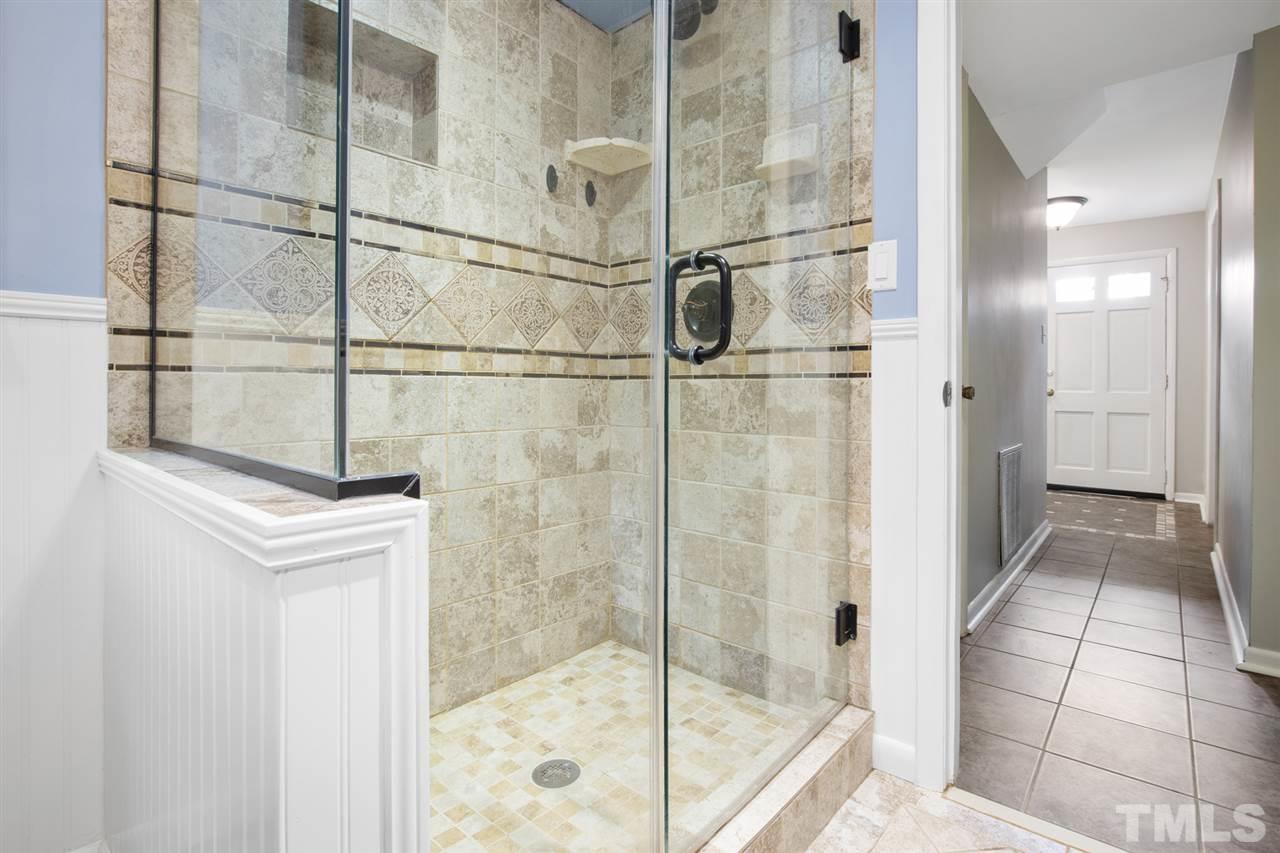 4605 Latimer Road Raleigh, NC 27609 - Photo 17 of 30 a bathroom with a shower and a mirror