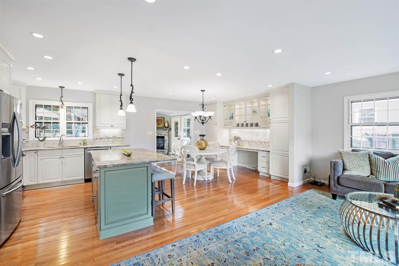 4605 Latimer Road Raleigh, NC 27609 - Photo 7 of 30 a living room with furniture a wooden floor and a kitchen view