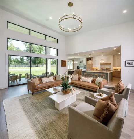 a living room with fireplace furniture and a large window