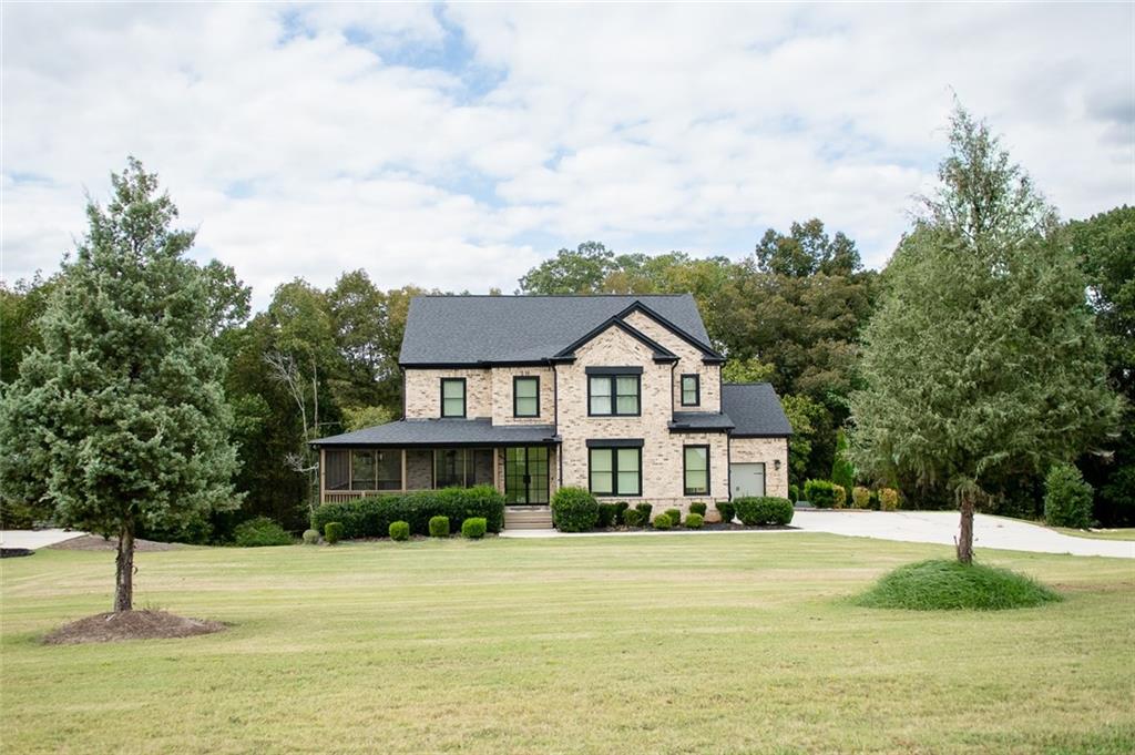 a front view of a house with a yard