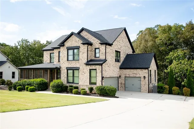 a front view of a house with a yard and garage