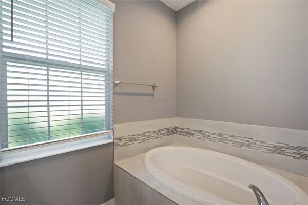 a bathroom with a bathtub and a window