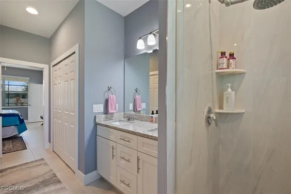 a bathroom with a sink vanity and mirror