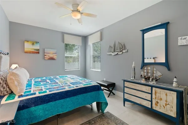 a bedroom with a bed dresser and a window