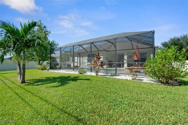 a patio with table and chairs under an umbrella