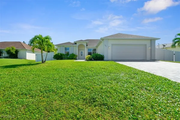 a front view of a house with a yard and garage