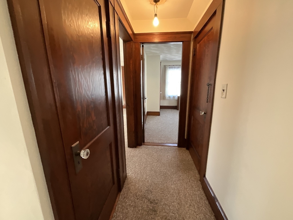 24 Pearl Street, Unit 2 Wakefield, MA 01880 - Photo 11 of 15 a view of hallway with a mirror