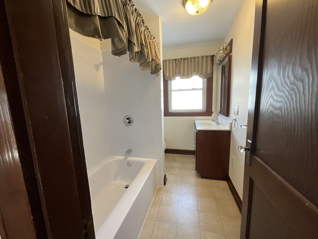 24 Pearl Street, Unit 2 Wakefield, MA 01880 - Photo 12 of 15 a bathroom with a bathtub a sink and a shower