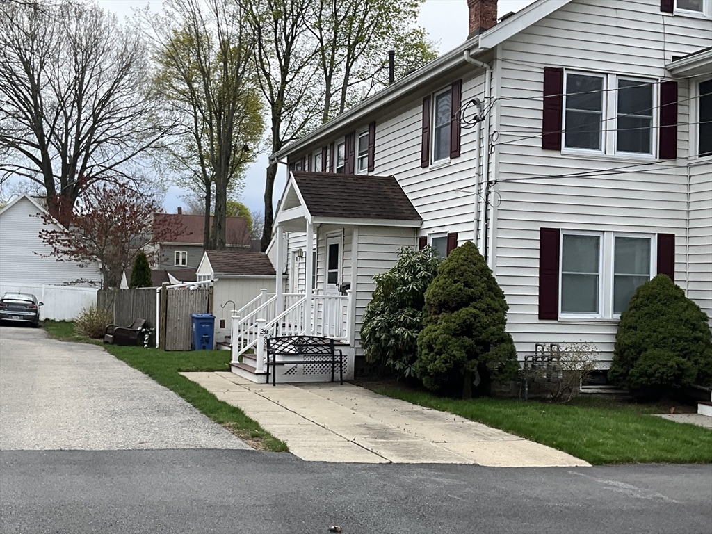 24 Pearl Street, Unit 2 Wakefield, MA 01880 - Photo 2 of 15 a front view of a house with a garden