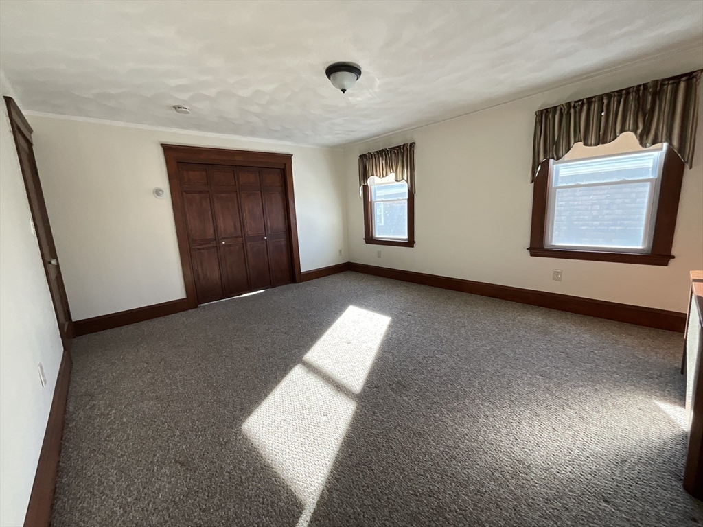 24 Pearl Street, Unit 2 Wakefield, MA 01880 - Photo 5 of 15 an empty room with windows