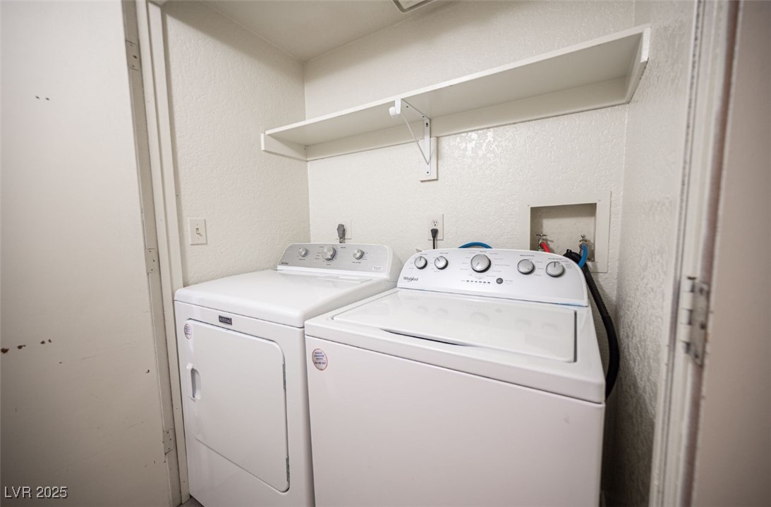 5336 Mancos Court, Unit 2 Las Vegas, NV 89119 - Photo 28 of 31 Washroom with a textured wall and washing machine and clothes dryer