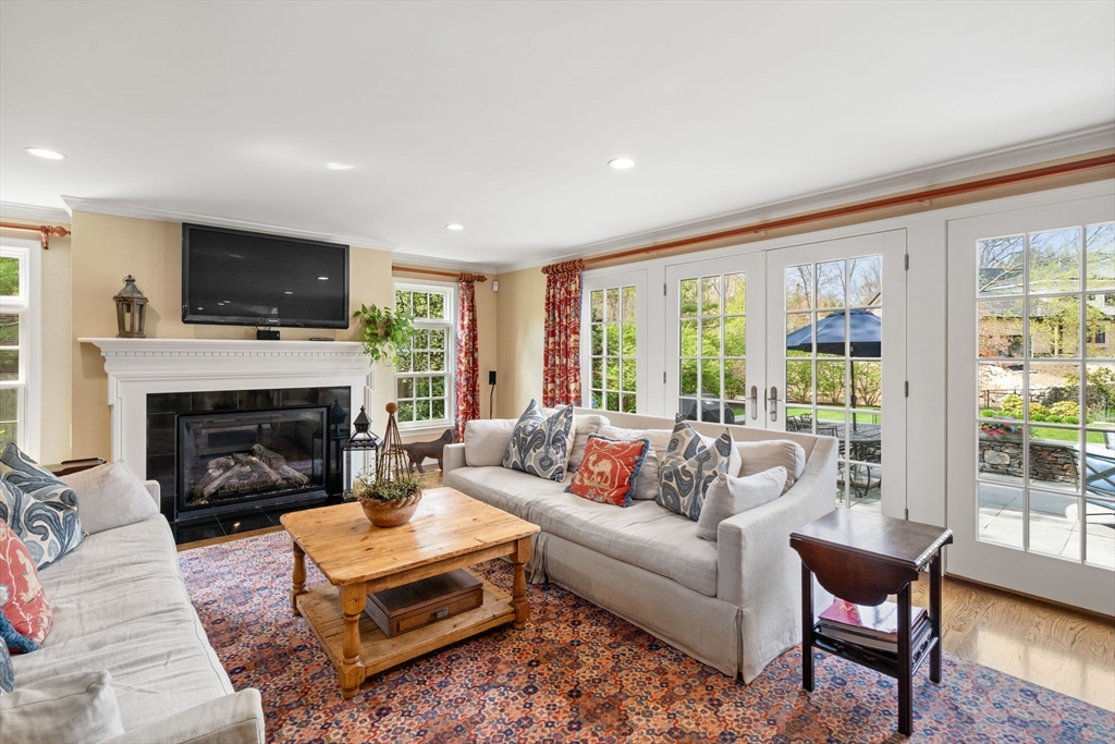 37 Oakridge Road Wellesley, MA 02481 - Photo 14 of 39 a living room with furniture a flat screen tv and a fireplace