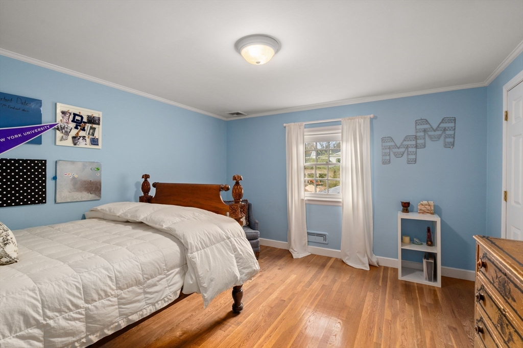 37 Oakridge Road Wellesley, MA 02481 - Photo 27 of 39 a bedroom with a bed and a wooden floor