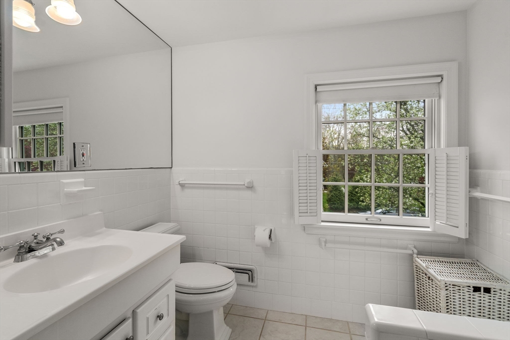 37 Oakridge Road Wellesley, MA 02481 - Photo 29 of 39 a bathroom with a sink a toilet and a mirror