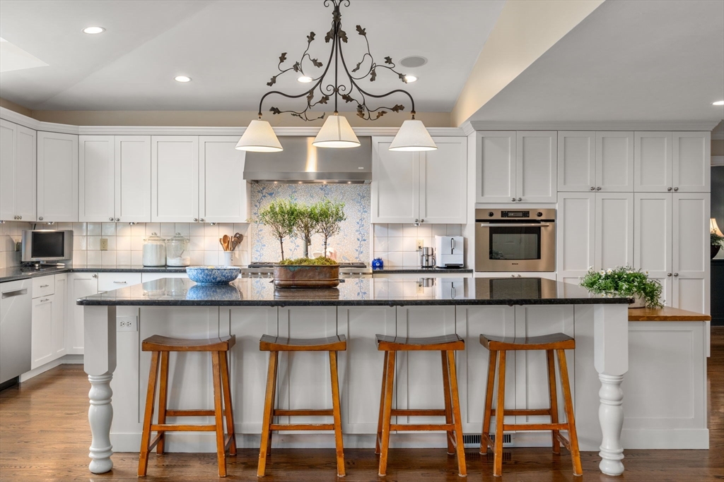 37 Oakridge Road Wellesley, MA 02481 - Photo 7 of 39 a kitchen with stainless steel appliances granite countertop a stove top oven a sink and cabinets