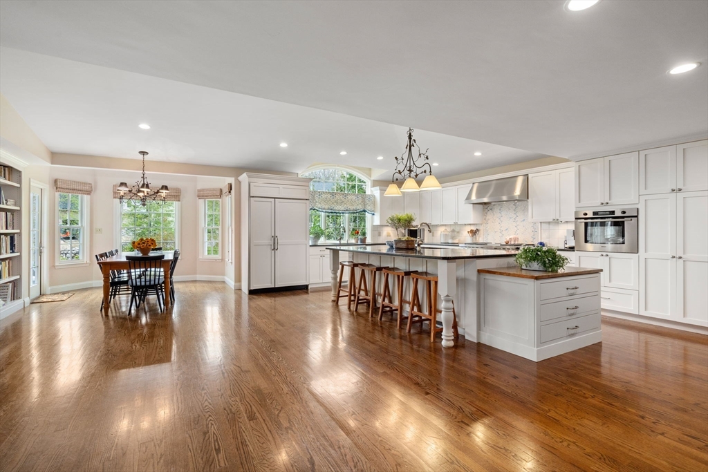 37 Oakridge Road Wellesley, MA 02481 - Photo 8 of 39 a open kitchen with granite countertop kitchen island stainless steel appliances a dining table and chairs