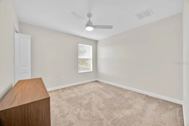 a spacious bedroom with a bed and a window