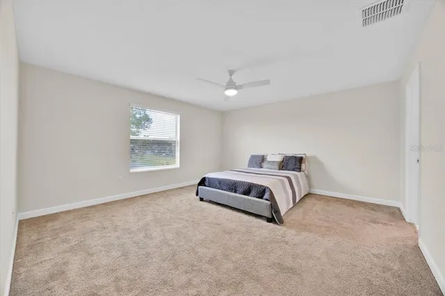 a bedroom with a bed and a night stand