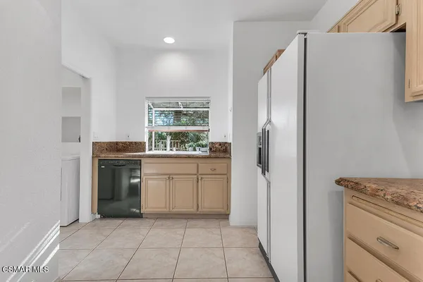 a kitchen with a stove a refrigerator and a sink