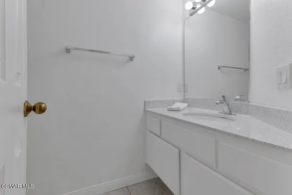 a bathroom with a sink and mirror