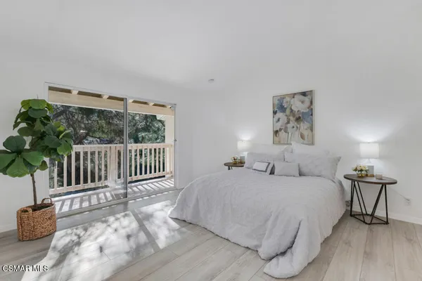 a bedroom with a bed and a painting on the wall