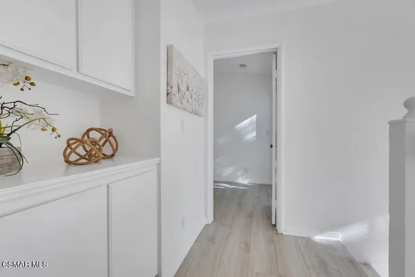 a view of a storage and utility room in wooden floor