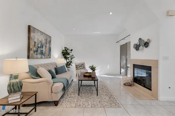 a living room with furniture and a fireplace