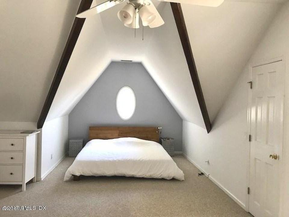 32 Ridge Street, Unit 2 Greenwich, CT 06830 - Photo 7 of 19 a bedroom with a bed and a mirror