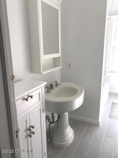 32 Ridge Street, Unit 2 Greenwich, CT 06830 - Photo 9 of 19 a bathroom with a sink a toilet and a mirror
