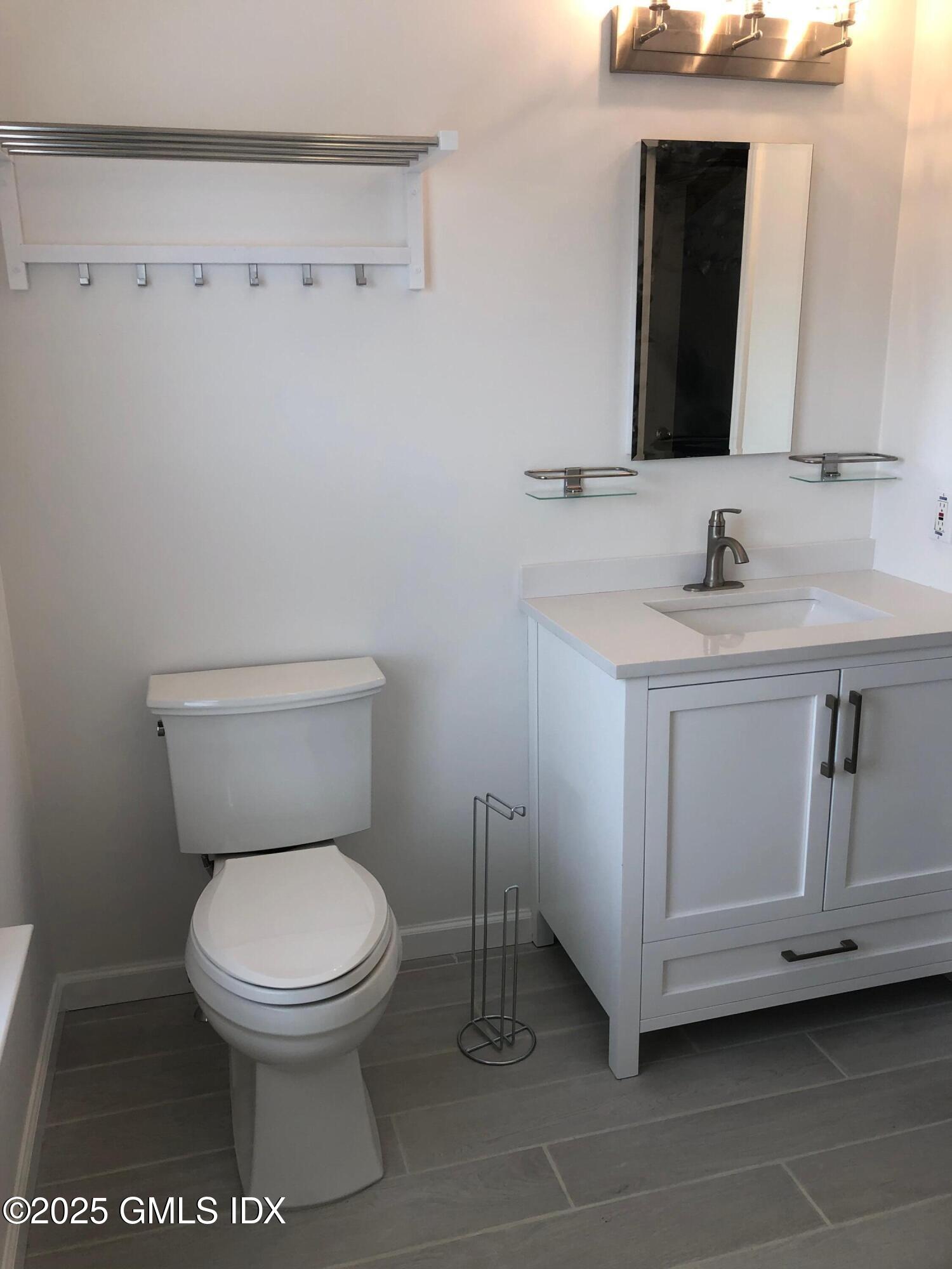 32 Ridge Street, Unit 2 Greenwich, CT 06830 - Photo 10 of 19 a white toilet sitting next to a bathroom sink