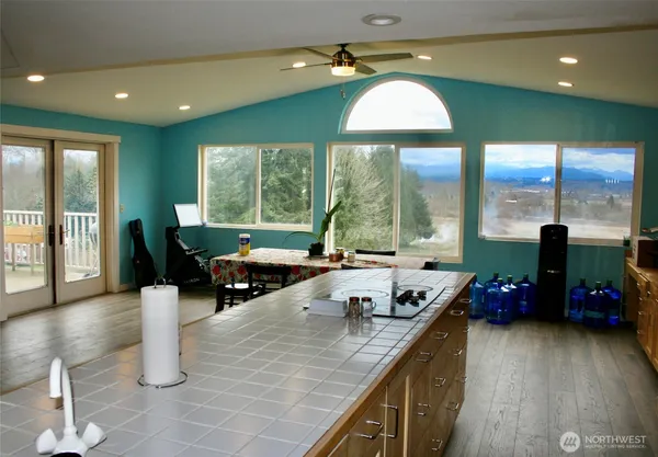 a kitchen with stainless steel appliances granite countertop a sink a stove and a wooden floors
