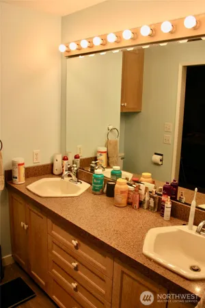 a bathroom with a double vanity sink and a mirror