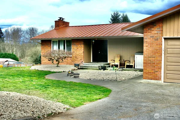 a view of a house with a yard and sitting area