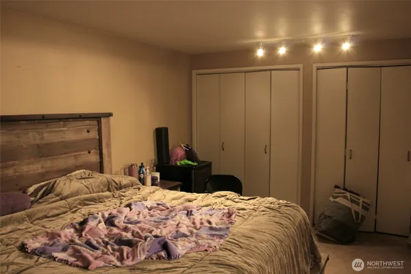 a bedroom with a bed and a closet
